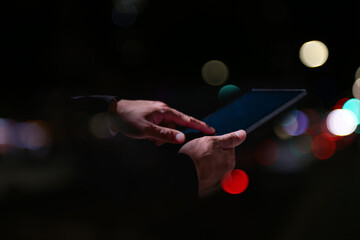 Businessman using digital tablet with futuristic virtual data interface, coding screen, and technology concept for innovation, cybersecurity, and information management.