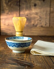 A traditional tea bowl and whisk on a wooden table