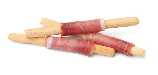 Delicious grissini sticks with prosciutto isolated on white