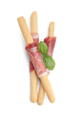 Delicious grissini sticks with prosciutto and basil isolated on white, top view
