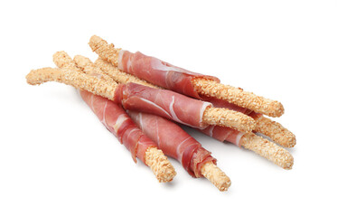 Delicious grissini sticks with sesame seeds and prosciutto isolated on white