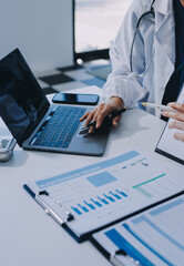 Medical team meeting analyzing blood test results in hospital laboratory. Doctors and scientists in lab coats are having a discussion about blood test result, holding test tubes and taking notes.