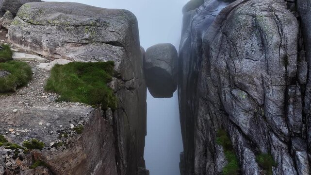 Drone footage of kjeragbolten boulder in foggy norway