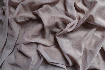 Draped dull dusky pink unprinted polyester mesh fabric
