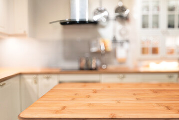 Wooden table with blurred modern kitchen background