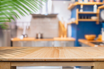 Wooden table surface with blurred cooking room and leaf pattern shadow