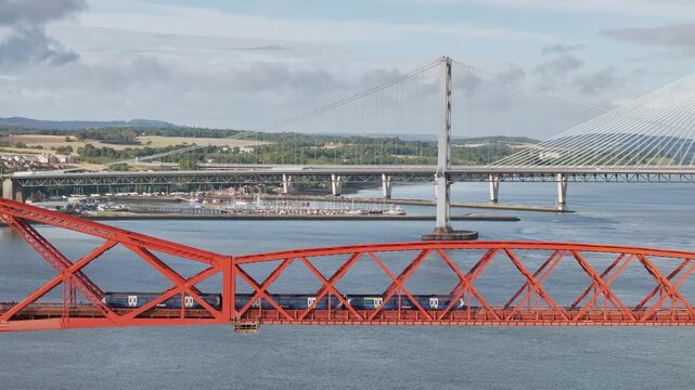 Trains on Forth Bridge from a drone, Queensferry Crossing, Forth Estuary, Scotland