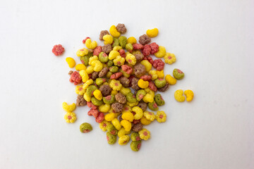 Colorful fruit flavored cereal isolated on white background.
