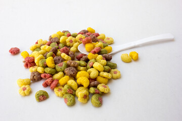 Colorful fruit flavored cereal isolated on white background.