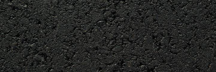 New dark black asphalt background. Closeup. Wide banner. Empty place for text. Top down view.