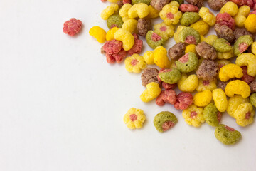 Colorful fruit flavored cereal isolated on white background.