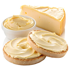 Creamy cheese spread on bagels with a wedge of cheese