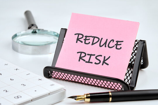 Conceptual reduce risk symbol. Copy space. Words REDUCE RISK on the sticker for memory
