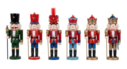 Isolated collection of wooden Nutcracker soldiers with staffs standing side by side on floor