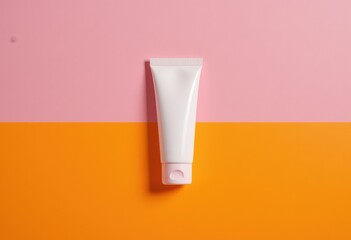 White cosmetic tube on pink and orange background for skincare branding mockup.