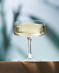 drink in a glass, plant shadows in background