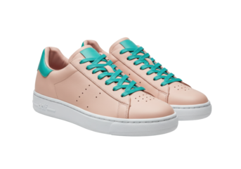 Isolated pastel pink leather sneakers with green accents fashionable footwear pair