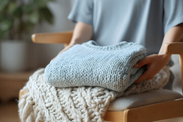 Blue knit sweater mockup folded with blanket in winter scene