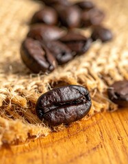 Obraz premium A detailed macro shot of a single dark roasted coffee bean on a rustic burlap surface, evoking the rich aroma and flavor of fresh coffee