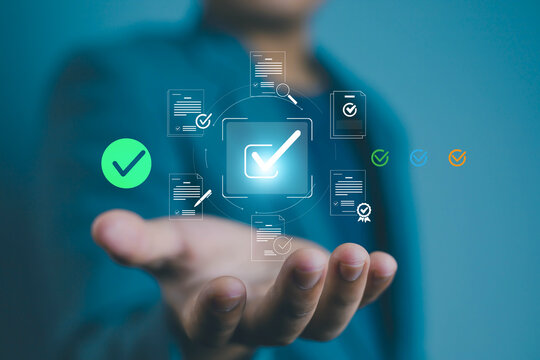 Businessman hand holding digital check mark icon with documents, concept of online approval, electronic signature, workflow automation, data validation, compliance, and secure business process.