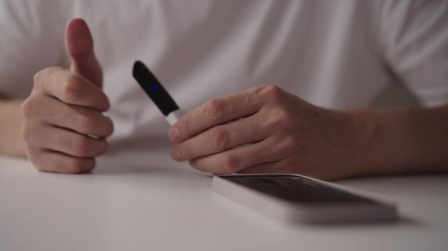 Close-up of male hands connecting OTG cable to smartphone, enabling data transfer, device charging and peripheral connection, showcasing mobile connectivity and technology integration, slow motion.