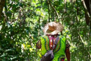 Local tour guide wearing traditional clothing walking through vibrant rainforest in Costa Rica, experiencing nature and local culture