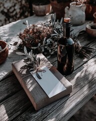 Olive oil bottle and wrapped gift | Mediterranean still life with herbs and linen textures | Natural daylight photography | Eco gift packaging concept