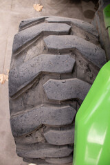 Street Sweeper Tire Tread Closeup. Macro closeup of rugged tire tread on a utility street sweeper, textured rubber detail with shallow depth and natural light; ideal for background, technical article