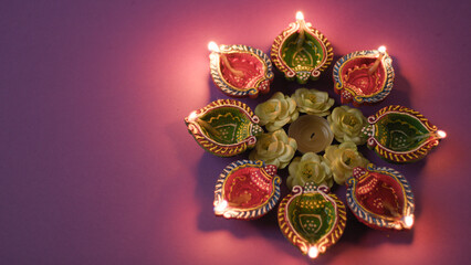 Lighting traditional Diwali candles in the night 