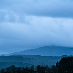 Sunrise on a cloudy day over mountains in the province of Salamanca, Spain, in shades of blue.