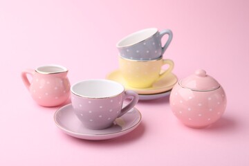 Beautiful tea set on pink background. Child's toy