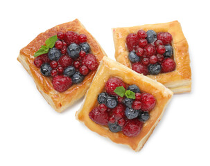 Tasty puff pastries with berries and mint isolated on white, top view