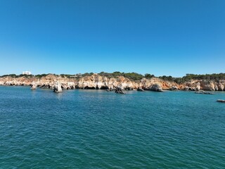 Fototapeta premium Cliffs of the Algarve between Portimao and Alvor, beautiful bays and beaches on the Atlantic Ocean.