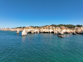 Fototapeta premium Cliffs of the Algarve between Portimao and Alvor, beautiful bays and beaches on the Atlantic Ocean.