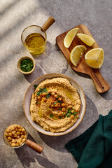 Delicious hummus with olive oil, chickpeas and parsley. Top view.