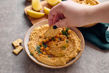 Delicious hummus with olive oil, chickpeas and parsley