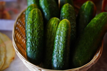A few cucumbers in a wicker basket. Harvesting.