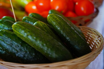 A few cucumbers in a wicker basket. Harvesting.