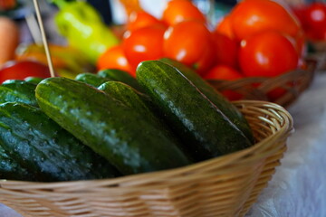 A few cucumbers in a wicker basket. Harvesting.