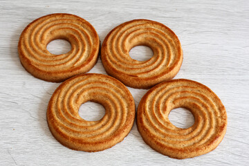 Ring-shaped shortbread cookies on a light background – breakfast or snack sweets