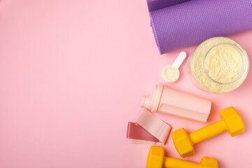 Protein shake with protein powder on a colored background. The powder is mixed with water or milk. A dietary supplement for a balanced diet. Whey protein. Fitness and gym diet nutrition.