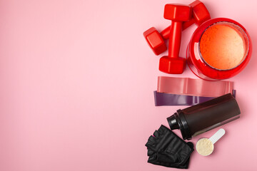Protein shake with protein powder on a colored background. The powder is mixed with water or milk....