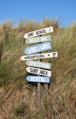 Wooden Signpost on the dunes at the beach in the North Sea