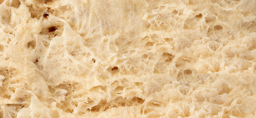 Focaccia flatbread slice macro texture, baked dough pattern. White bread loaf cut close up