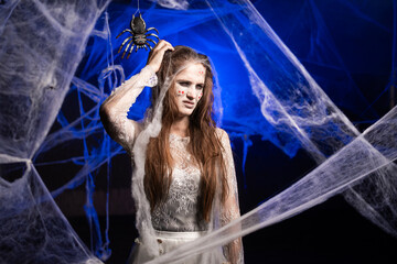 sad puzzled confused sinister woman with scary Halloween zombie makeup hold scratch head. Dead girl...