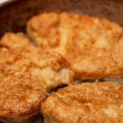 Golden fried chicken cutlets in a skillet. Crispy texture and appetizing appearance