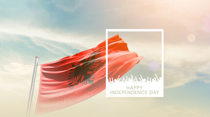 Albania flag waving proudly under a bright sky with text happy independence day. Albania national flag for independence day.