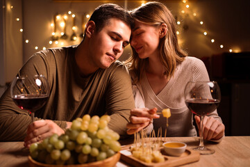 Couple in love celebrating Valentine's day having dinner at home. Concept of happy Valentines Day.