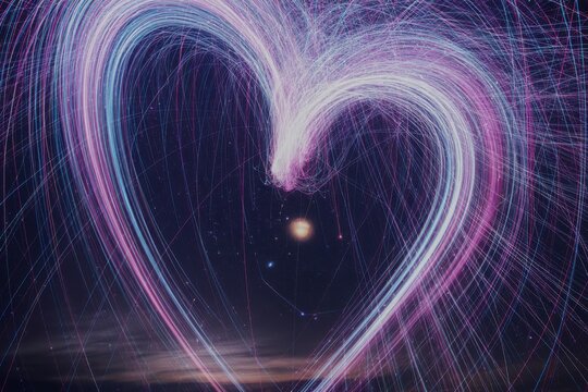 Abstract heart shape formed by light trails in dark space - Powered by Adobe