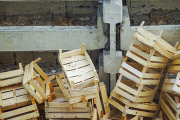 Pile of discarded wooden fruit crates stacked against wall. Raw face of consumerism. Concepts of recycling, eco-friendly packaging and waste management solutions. Call for ecological responsibility